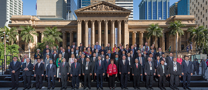 Asia Pacific Cities Summit 2015 international delegates and keynote speakers gather in front of Brisbane City Hall.