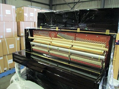One of the 10 pianos intercepted falsely claiming to be Australian Made. The pianos carried an assortment of misleading country of origin logos and stamps.